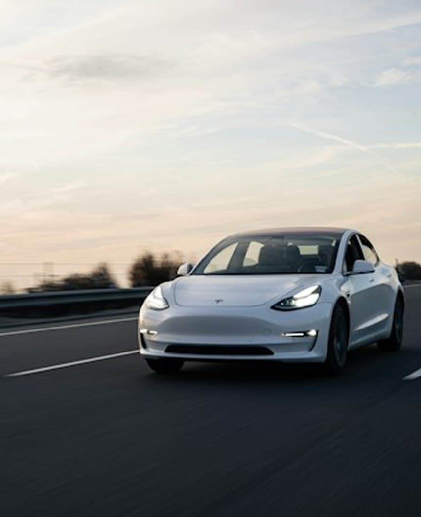 Electric car driving on an open road